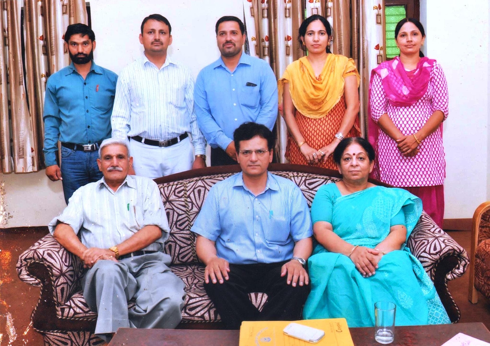 Inspection team with college staff, seated group portrait indoors