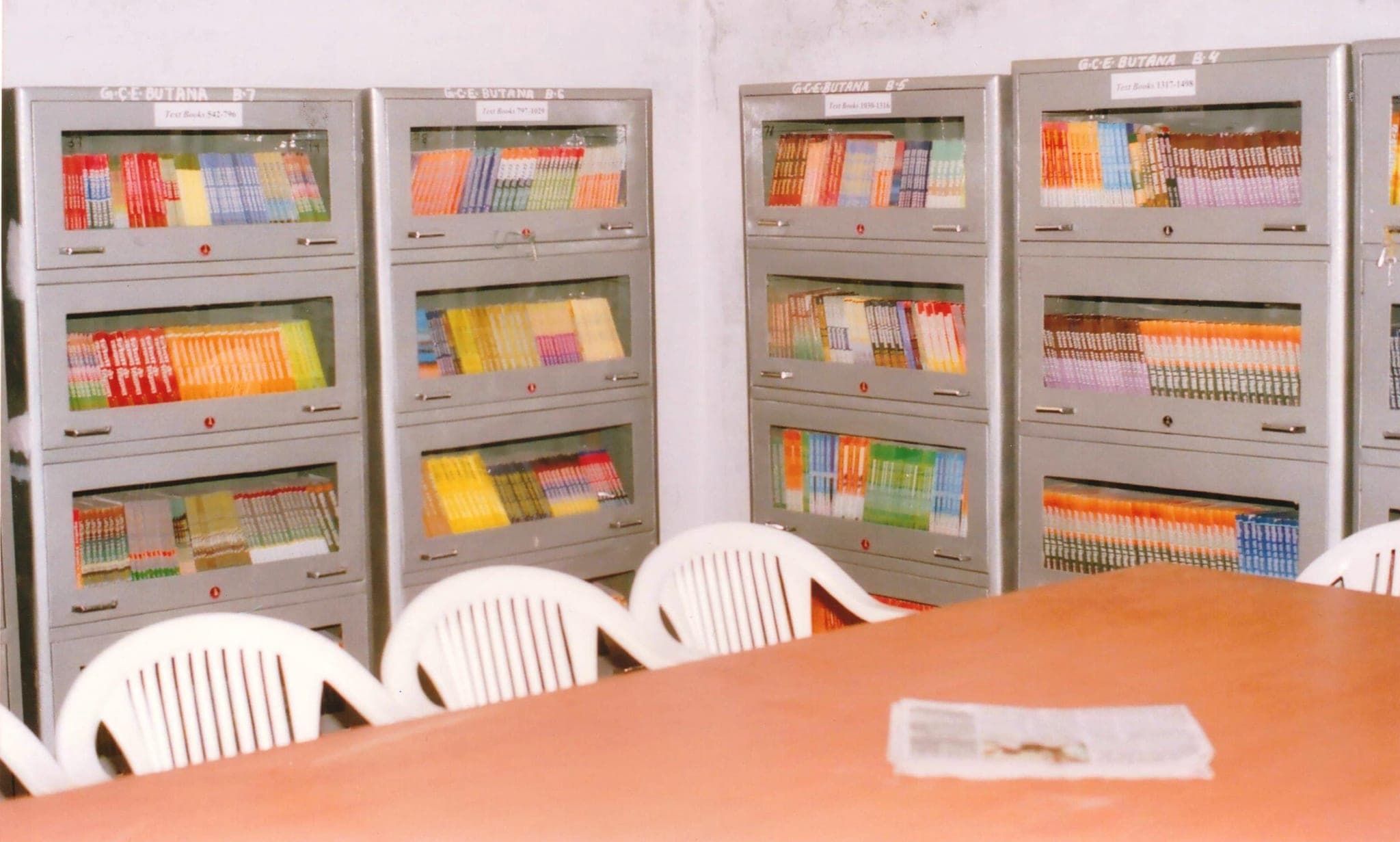 Library book stacks, a further row of textbook almirahs
