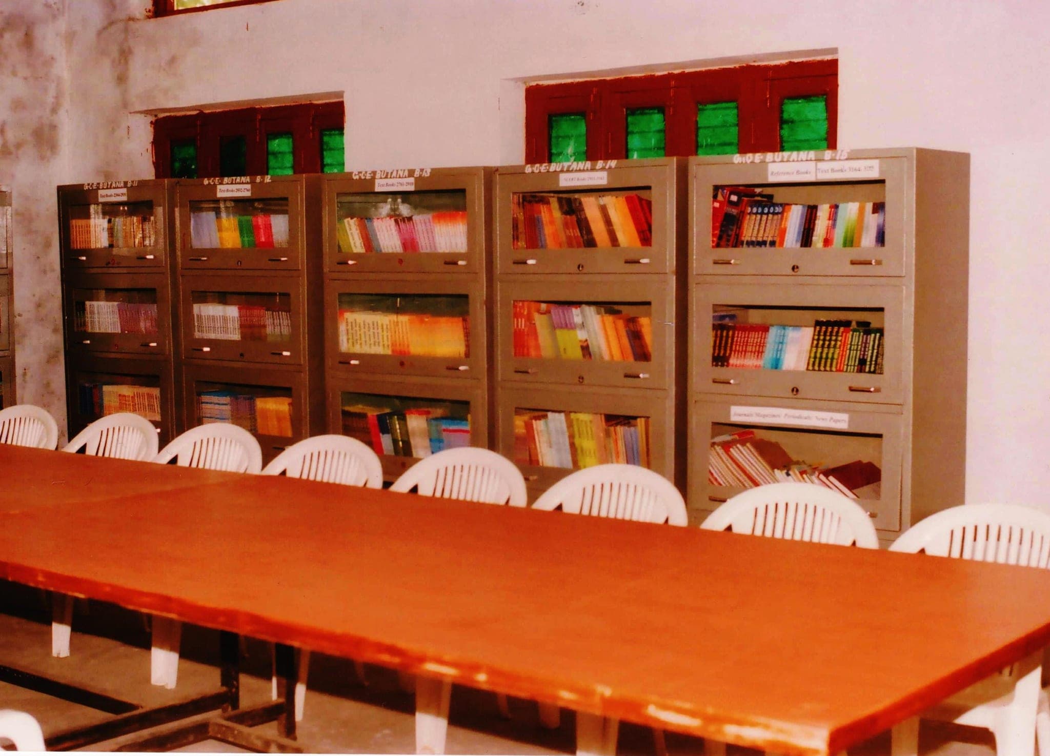 Library book stacks with the reference books and periodicals section
