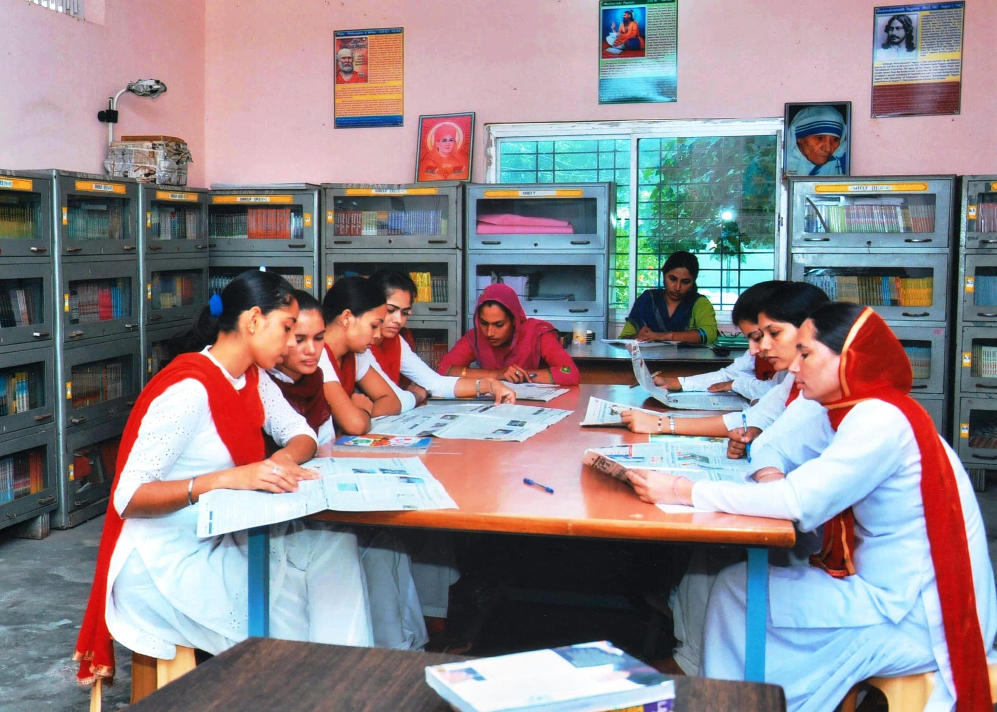 Library reading room, pupil-teachers reading newspapers at the table